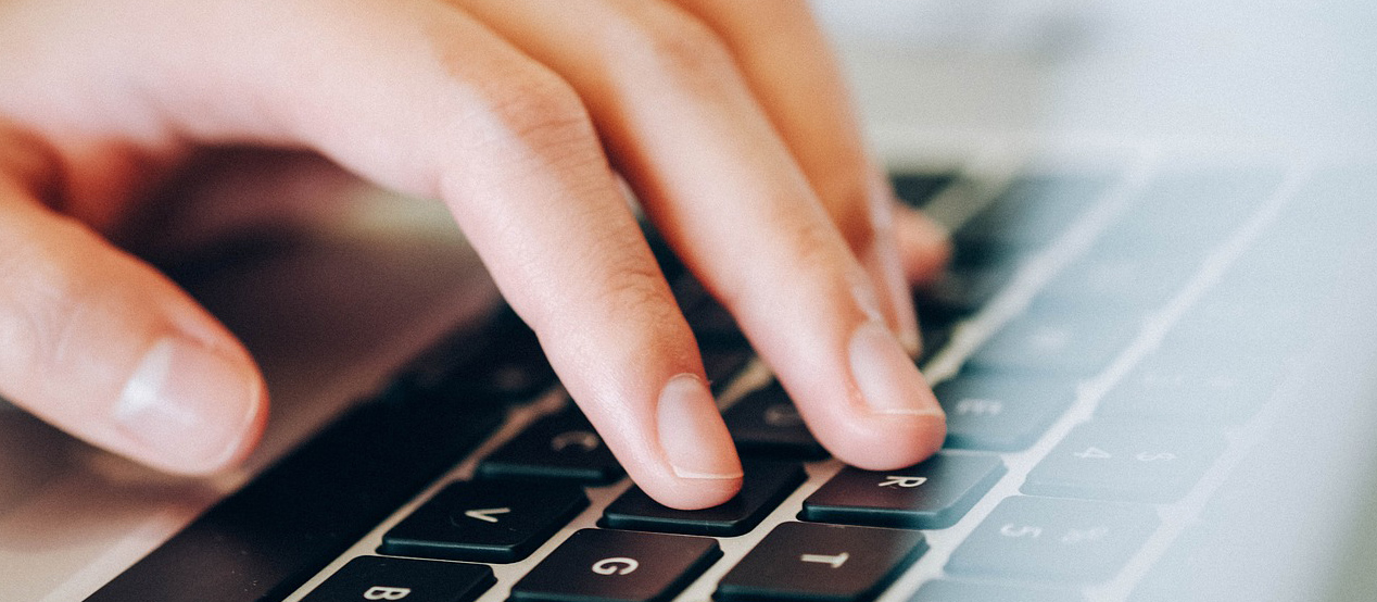 Hand typing on keyboard